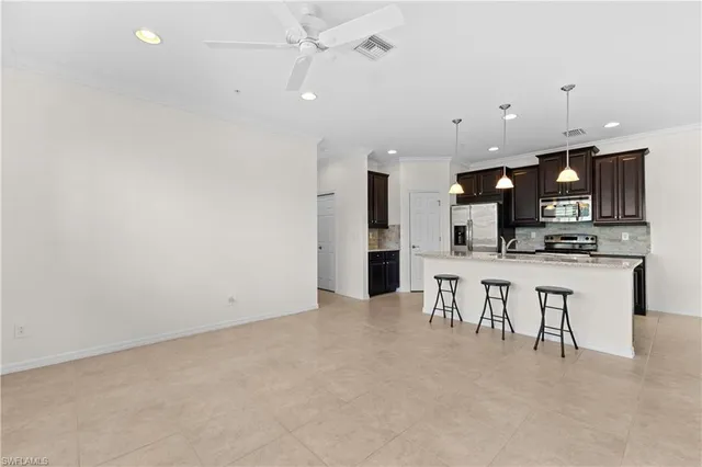 a view of kitchen with microwave and refrigerator