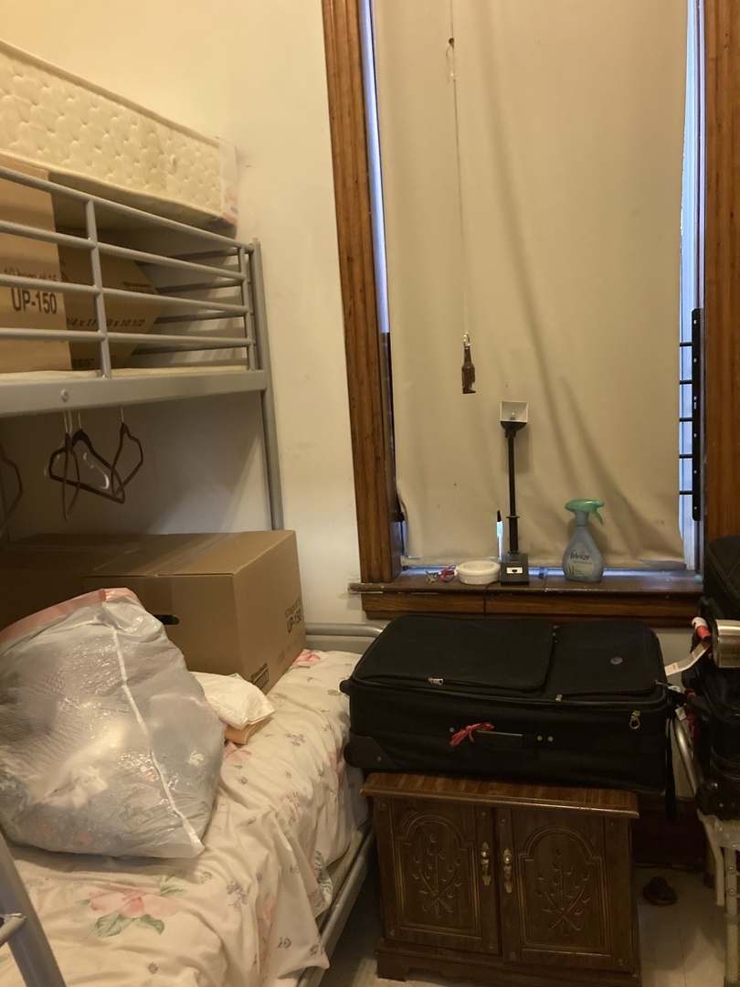 910 West 32nd Place Chicago, IL 60608 - Photo 11 of 28 a bed sitting in a bedroom next to a window