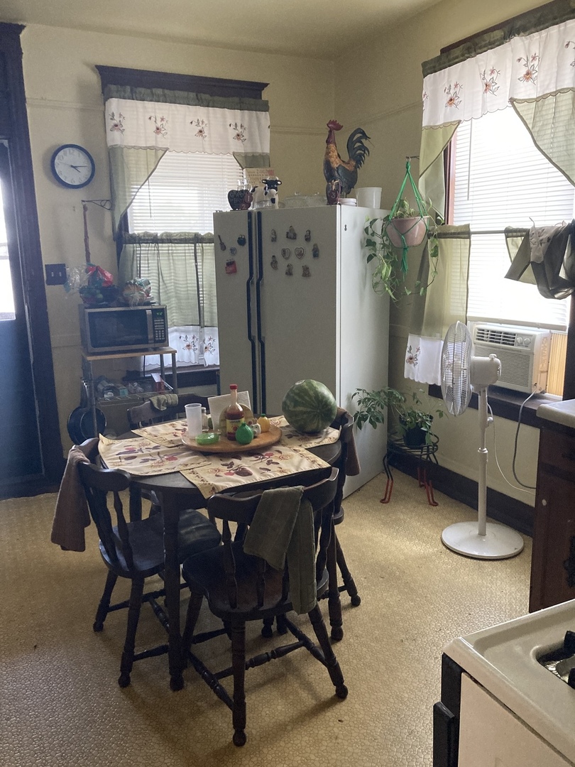 910 West 32nd Place Chicago, IL 60608 - Photo 21 of 28 a view of a dining room with furniture and a chandelier