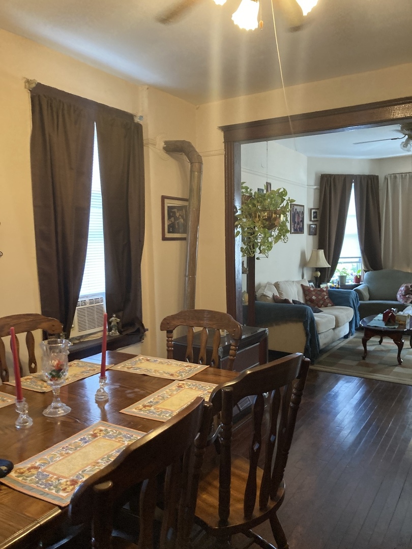 910 West 32nd Place Chicago, IL 60608 - Photo 27 of 28 a kitchen with a table chairs and a stove
