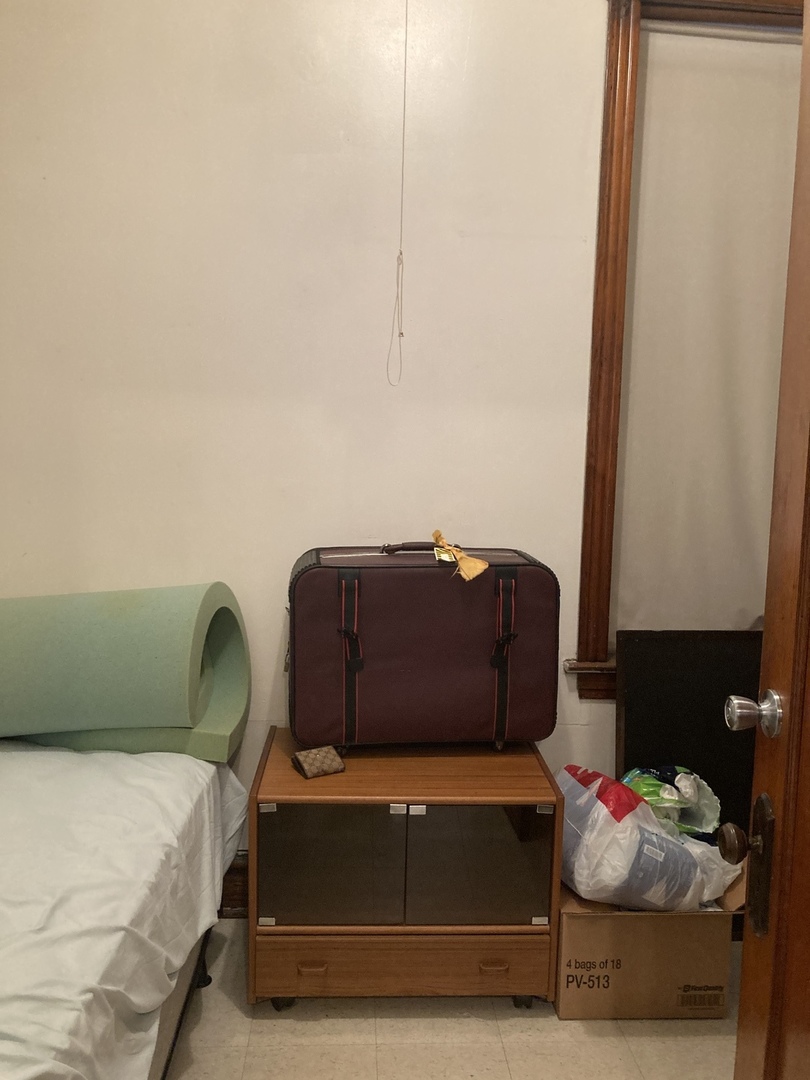 910 West 32nd Place Chicago, IL 60608 - Photo 6 of 28 a bed sitting in a bedroom next to a window
