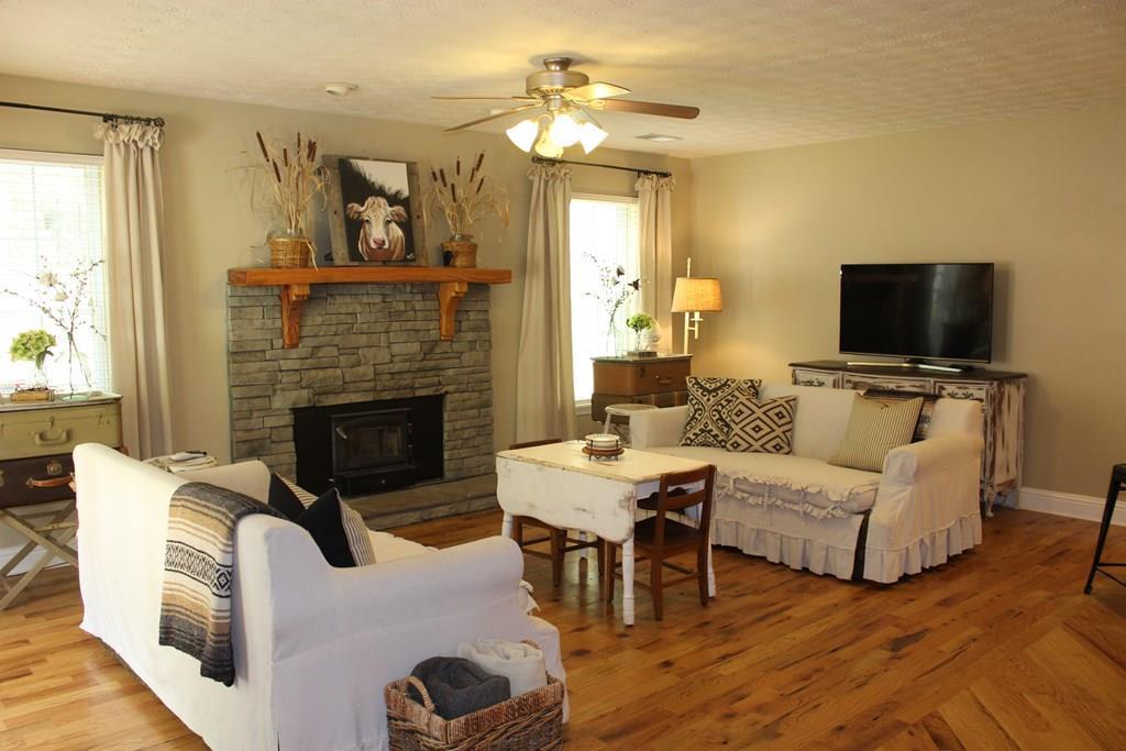 375 Old Cabaniss Road Forsyth, GA 31029 - Photo 2 of 23 a living room with furniture a fireplace and a flat screen tv
