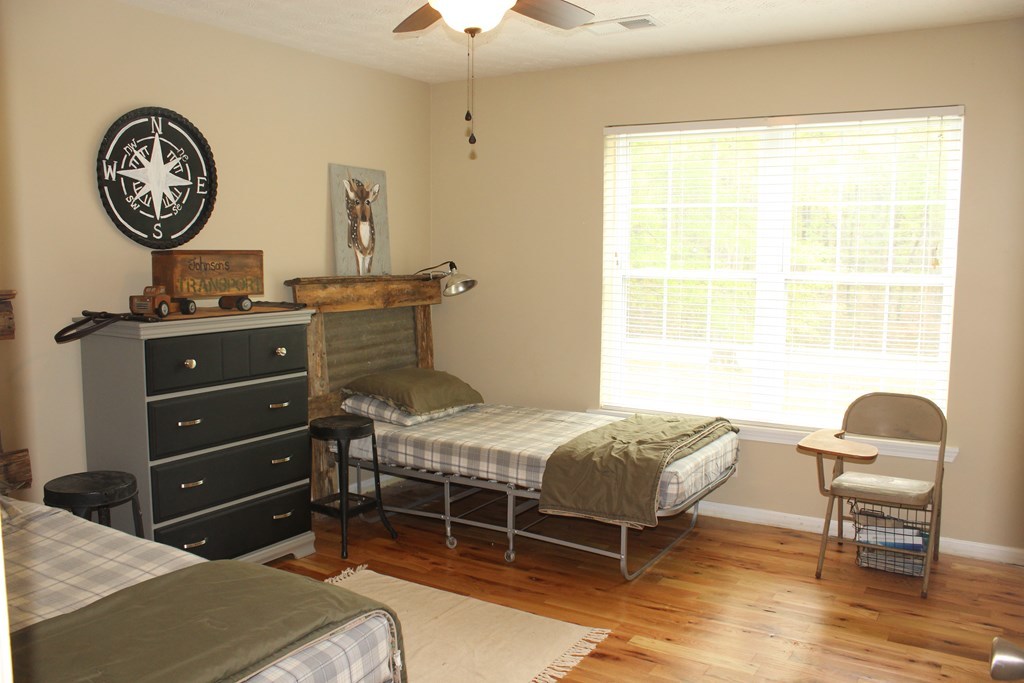375 Old Cabaniss Road Forsyth, GA 31029 - Photo 13 of 23 a bedroom with a bed and a chair