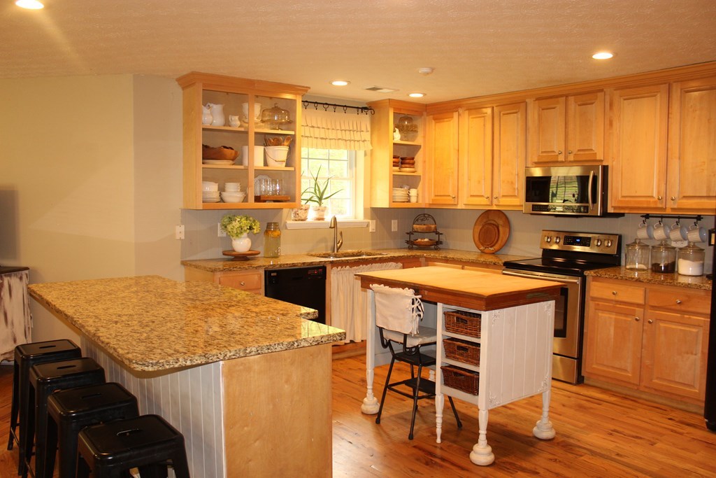 375 Old Cabaniss Road Forsyth, GA 31029 - Photo 5 of 23 a kitchen with a stove a sink and a refrigerator