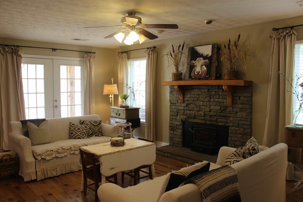 375 Old Cabaniss Road Forsyth, GA 31029 - Photo 7 of 23 a living room with furniture a fireplace and a large window