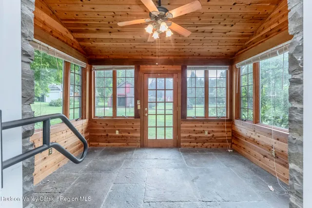 a bedroom with furniture and a large window