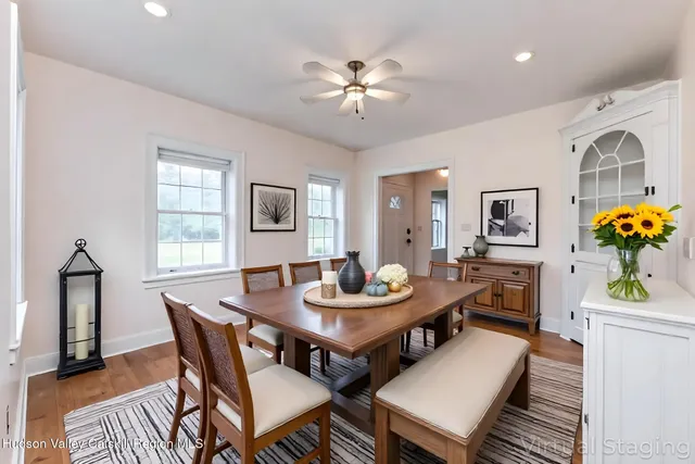 a dining room with furniture and window