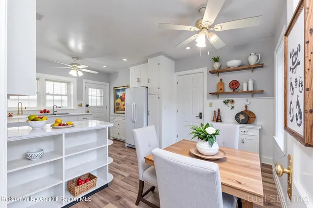 a view of a dining room with furniture a chandelier and wooden floor