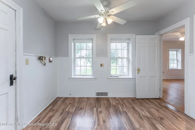 wooden floor in an empty room with a window