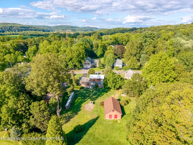 an aerial view of residential houses with yard