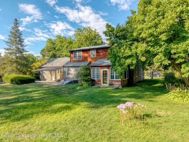 a front view of a house with a yard table and chairs