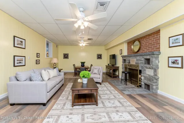 a living room with furniture dining table and a fireplace