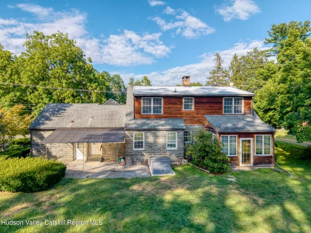 a front view of a house with a yard table and chairs