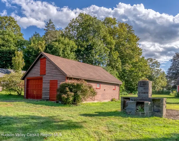 a aerial view of a house with a yard potted plants and large tree