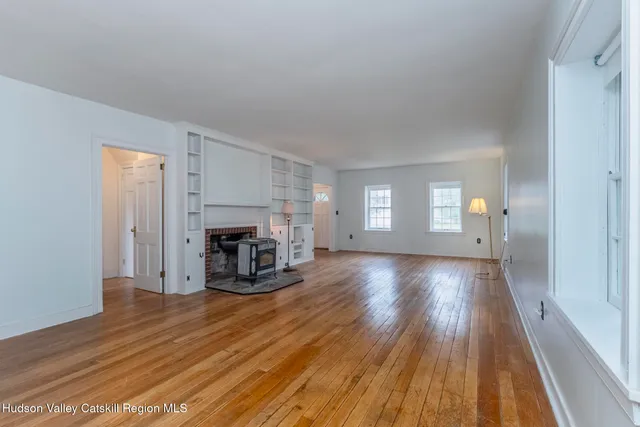 a view of a livingroom with a fireplace and window