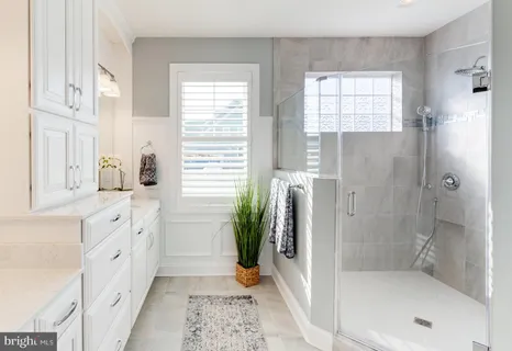 a view of a dining room with furniture and a potted plant