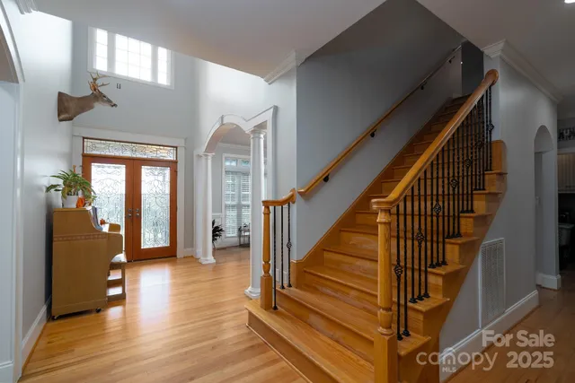 a view of entryway and hall with wooden floor