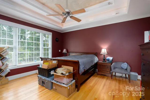 a bedroom with furniture and a large window