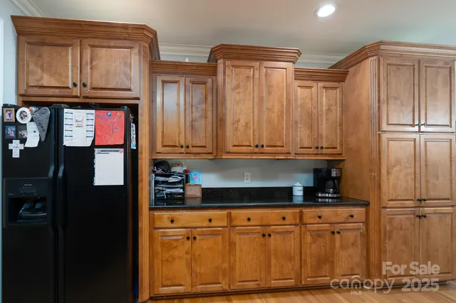 a kitchen with stainless steel appliances granite countertop a refrigerator and cabinets