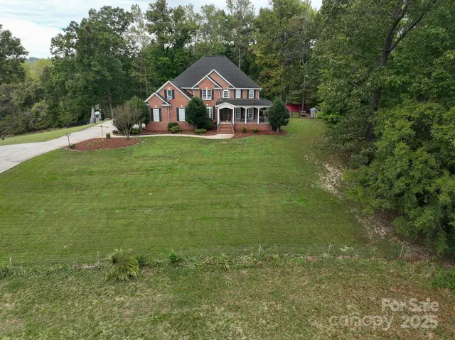 a house with green field in front of it
