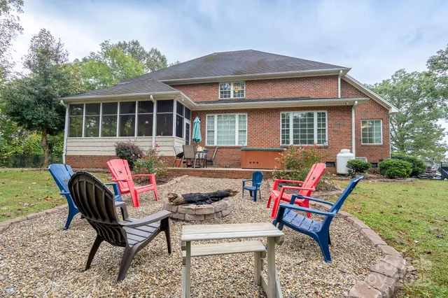 a view of a house with a backyard and sitting area