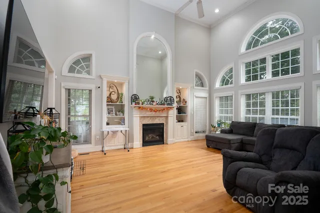 a living room with furniture fireplace and window