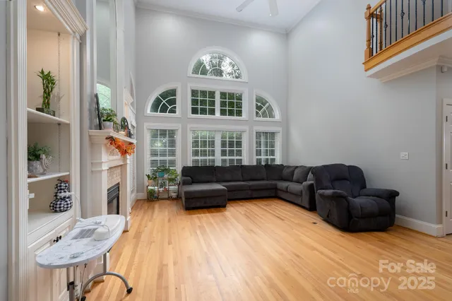 a living room with furniture fireplace and a window