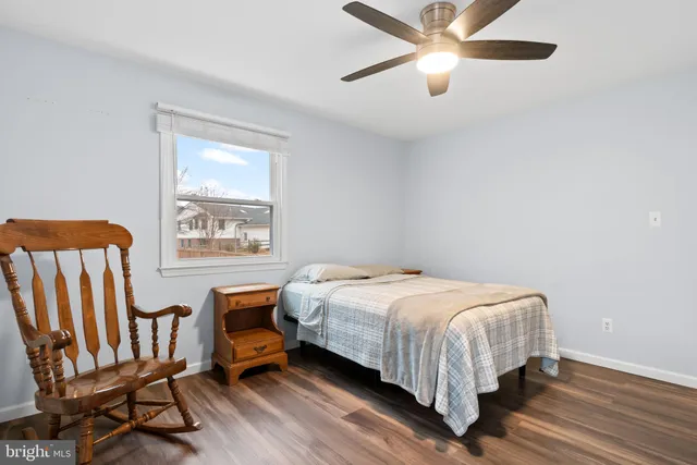 a bed sitting in a bedroom next to a window