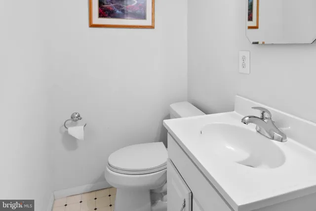 a white toilet sitting next to a bathroom sink