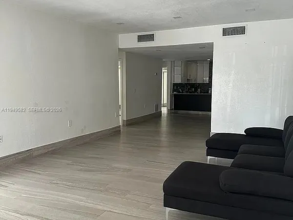 a view of an empty room and wooden floor