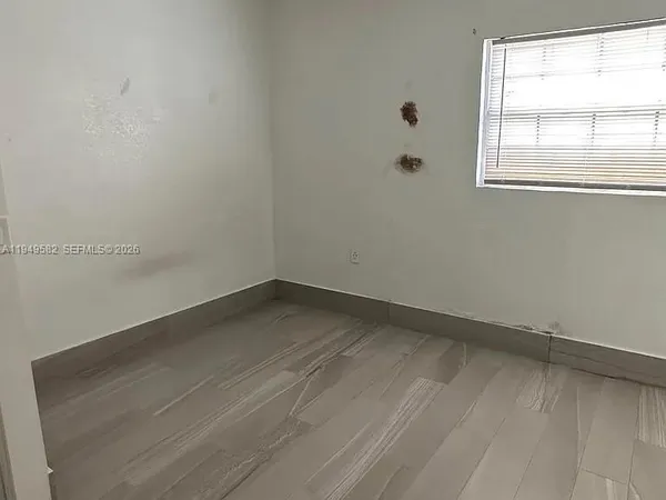 an empty room with wooden floor