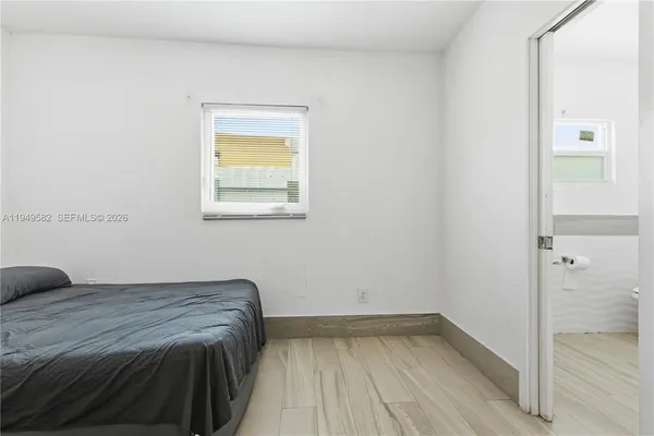 a bedroom with a bed and a window