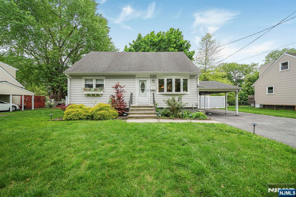 52 Barbara Drive Pompton Lakes, NJ 07442 - Photo 2 of 30 a front view of a house with a garden and porch