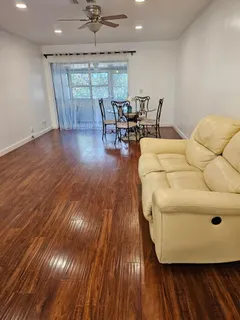 a dining room with wooden floor and furniture