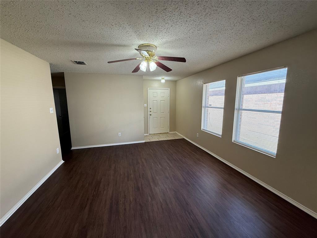 7541 Marietta Lane Dallas, TX 75241 - Photo 2 of 10 wooden floor in an empty room with a window