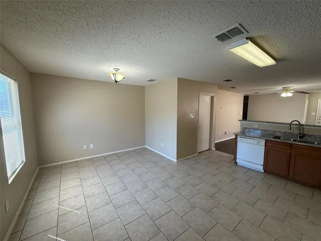 a view of a kitchen with a sink and a living room