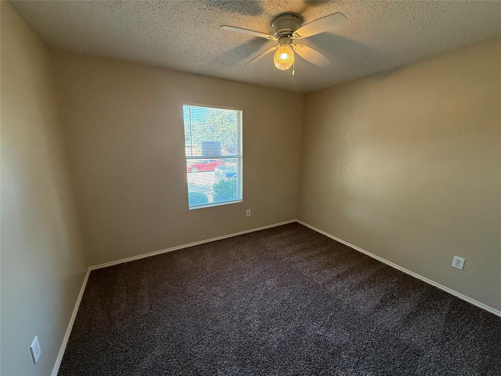 7541 Marietta Lane Dallas, TX 75241 - Photo 7 of 10 an empty room with a window and a fan