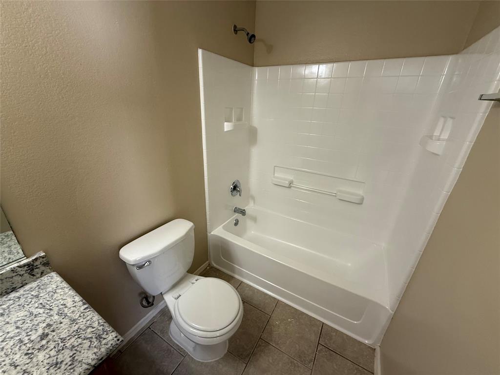 7541 Marietta Lane Dallas, TX 75241 - Photo 10 of 10 a white toilet sitting next to a bath tub