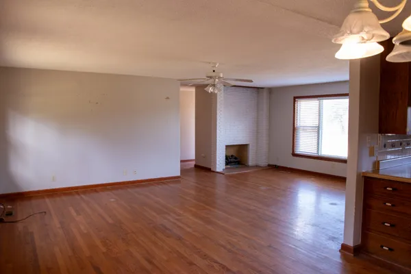wooden floor in an empty room with a window