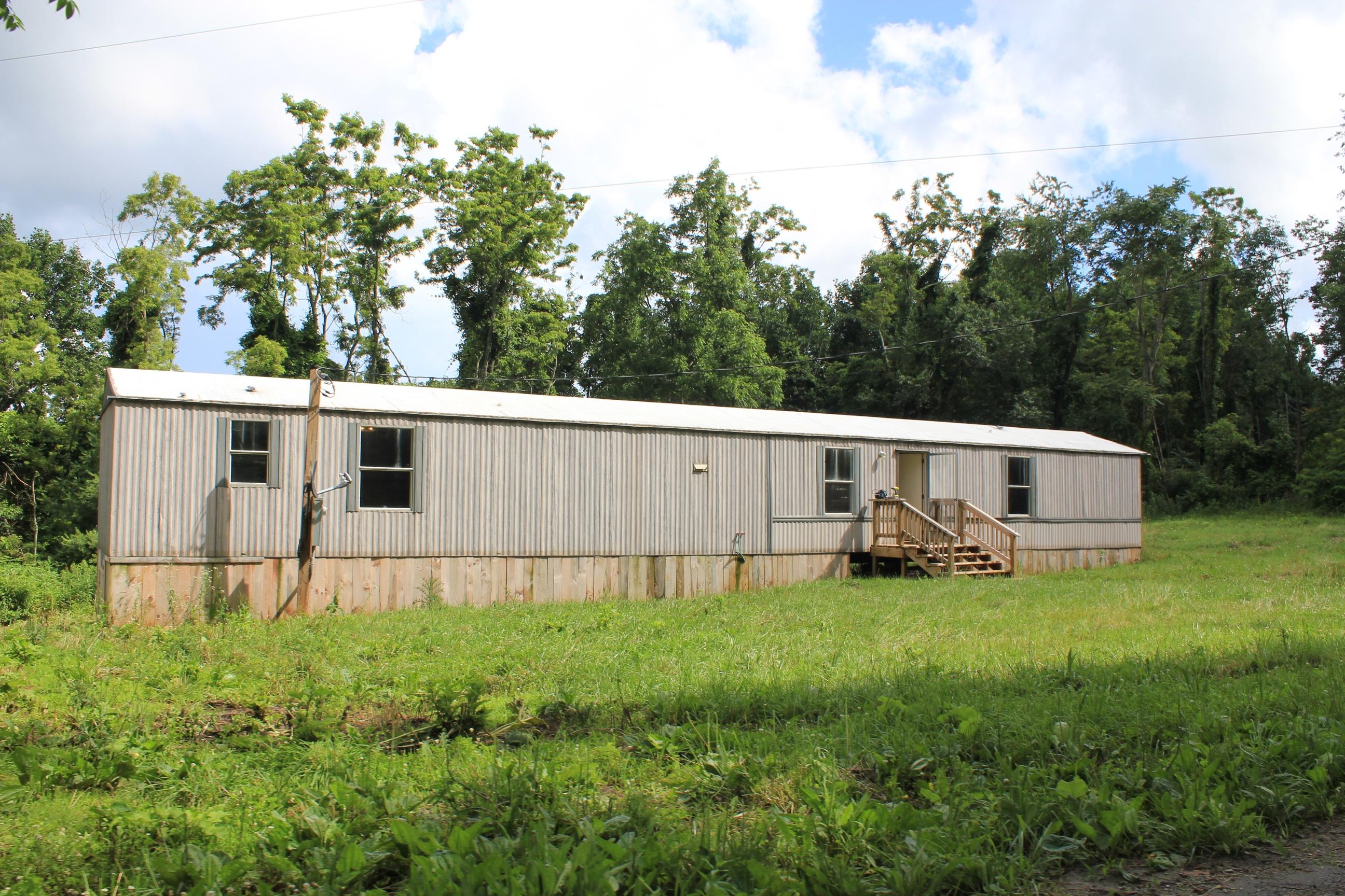 842 Countyline Church Road Southeast Floyd, VA 24091 - Photo 2 of 4 a view of a backyard with plants and a patio