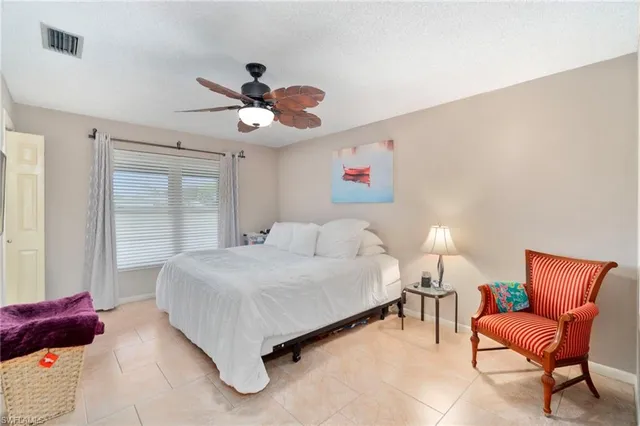 a spacious bedroom with a bed and a couch