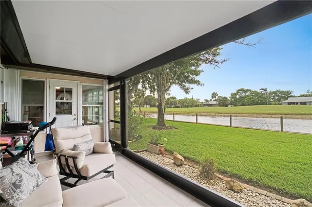 a livingroom with furniture and a large window