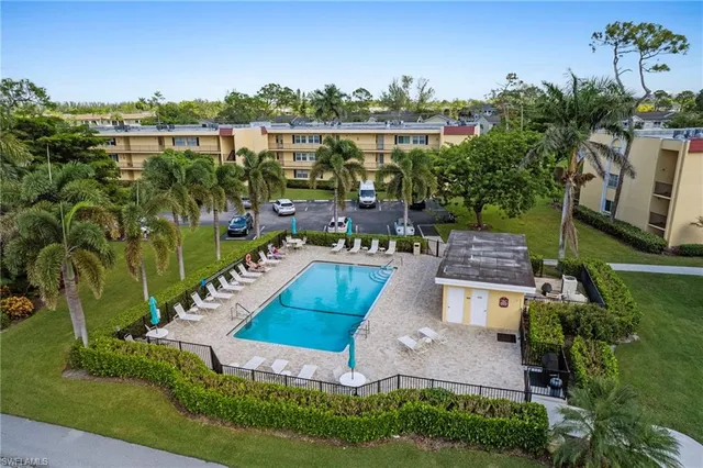 an aerial view of a house with outdoor space patio and lake view