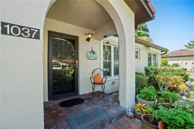 a front view of a house with outdoor seating