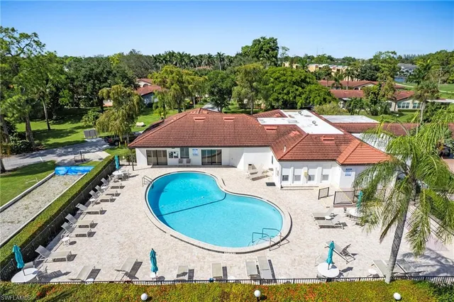 an aerial view of multiple houses with a big yard