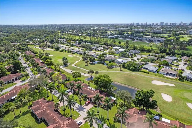 an aerial view of residential houses with outdoor space and street view