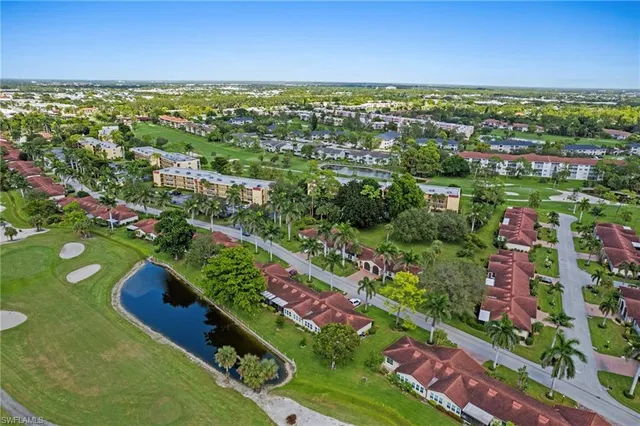 an aerial view of house with swimming pool and garden