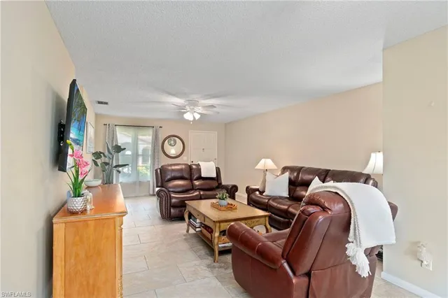 a living room with furniture and a clock