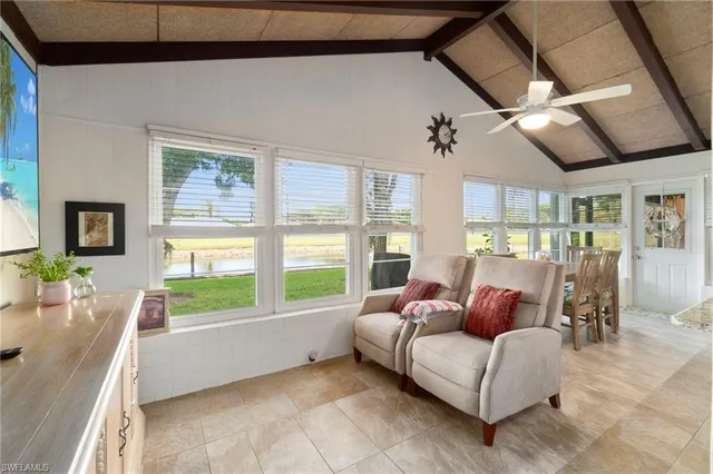 a living room with furniture and a floor to ceiling window