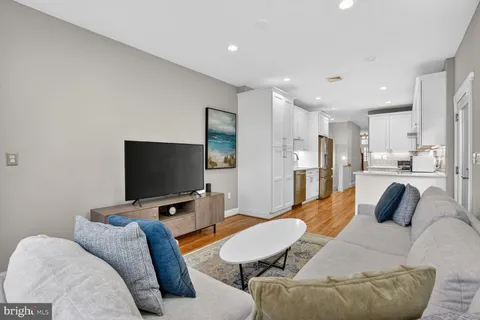 a kitchen with stainless steel appliances kitchen island granite countertop a refrigerator and a sink